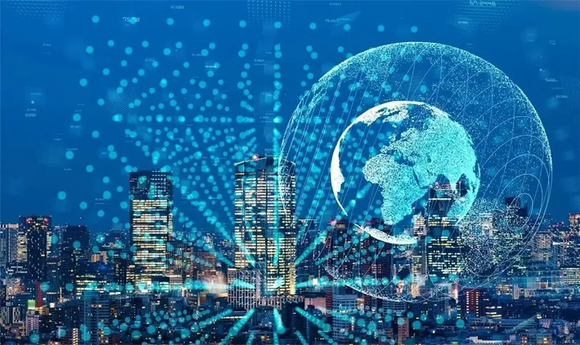 hero-img A cityscape at night with lighted buildings, overlaid by a digital globe and interconnected dots, representing global communication or technology networks.
